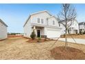 Charming two-story home with light gray siding, a two-car garage, and minimal front yard landscaping at 2036 Avalon Rdg, Conyers, GA 30013