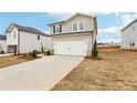 View of the home showing its two-car garage and landscaping at 2038 Avalon Rdg, Conyers, GA 30013