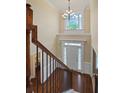 Two-story entryway with hardwood floors, a chandelier, and a view of the front door at 3247 Brigadier Way, Stockbridge, GA 30281