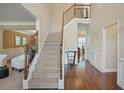 Two-story entryway with hardwood floors, a staircase with iron railing, and neutral color palette at 3247 Brigadier Way, Stockbridge, GA 30281