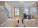 Bright home office with hardwood floors, two armchairs, and a desk with two computers at 3247 Brigadier Way, Stockbridge, GA 30281