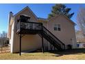 Elevated deck with stairs leading to the backyard, offering extra outdoor space at 114 Muirwood Dr, Temple, GA 30179