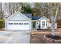 Nice curb appeal! Light green house with a white garage door and landscaping at 2403 Barndale Dr, Lawrenceville, GA 30044