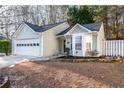 Ranch style home with a white garage door and mature trees at 2403 Barndale Dr, Lawrenceville, GA 30044