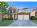 Traditional brick home features a two-car garage, manicured lawn, and covered front entry at 4685 Prater Se Way, Smyrna, GA 30080