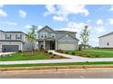 Two-story house with gray siding, landscaping, and a two-car garage at 2042 Blackbird Cir, Covington, GA 30016