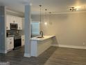 Modern kitchen with white cabinets, quartz countertops, and island at 556 Paines Nw Ave, Atlanta, GA 30318