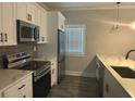 Modern kitchen with stainless steel appliances, marble countertops, and plenty of storage at 556 Paines Nw Ave, Atlanta, GA 30318