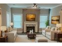 Cozy living room featuring a fireplace, modern furniture, and large windows with natural light at 556 Paines Nw Ave, Atlanta, GA 30318