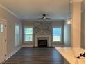 Open living space with a stone fireplace, hardwood floors, and large windows for natural light at 556 Paines Nw Ave, Atlanta, GA 30318