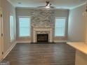 Bright living room featuring a stone fireplace and wood-look floors at 556 Paines Nw Ave, Atlanta, GA 30318
