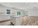 Well-lit kitchen features an island, stainless steel appliances, white cabinets and granite countertops at 386 Rock View Ln, Covington, GA 30016