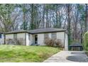 Front view of a white brick ranch house with a driveway and carport at 2740 Rollingwood Se Ln, Atlanta, GA 30316