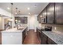 Modern kitchen with granite countertops and dark cabinetry at 6094 Whitetail Deer Run, Mableton, GA 30126