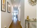 Bright hallway with hardwood floors, art, and a console table at 7144 Gladstone Cir, Stonecrest, GA 30038