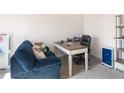 Bright home office featuring a desk, comfortable couch, and built-in shelving at 7767 Richmond Trl, Fairburn, GA 30213