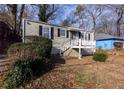 Tan house with white steps and porch, and neatly trimmed shrubs at 1110 1St Nw St, Atlanta, GA 30318