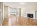 Living room featuring hardwood floors, a fireplace, and a bay window at 3712 Windy Hill Se Dr, Conyers, GA 30013