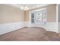 Bright dining room with bay window and wainscoting at 3055 Cooper Woods Ln, Loganville, GA 30052