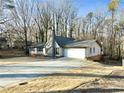 House exterior with a long driveway and mature trees at 4522 Karron Ln, Powder Springs, GA 30127