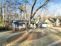 House exterior showcasing landscaping and a tree in the front yard at 4522 Karron Ln, Powder Springs, GA 30127