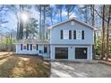Newly renovated light blue home with a two-car garage and manicured lawn at 4611 Eberline Ct, Stone Mountain, GA 30083