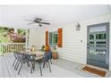 Covered porch with dining set and ceiling fan at 3918 Hardee Nw Dr, Kennesaw, GA 30152