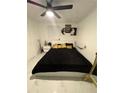 Modern bedroom with a black-patterned comforter and a ceiling fan, perfect for relaxation at 1876 Connally Dr, East Point, GA 30344