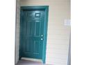 Teal front door to condo unit with warning sign at 9400 Roberts Dr # 1C, Atlanta, GA 30350