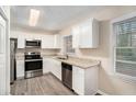 Modern kitchen with white cabinets, granite counters, and stainless steel appliances at 2224 Polar Rock Sw Ave, Atlanta, GA 30315