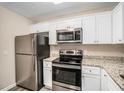 Stainless steel appliances and granite countertops in this updated kitchen at 2224 Polar Rock Sw Ave, Atlanta, GA 30315