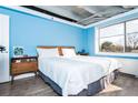 Cozy bedroom with a large window, wood floors, and a comfortable queen-sized bed at 2479 Peachtree Ne Rd # 202, Atlanta, GA 30305