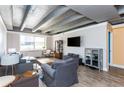 Modern living room with exposed ceiling, hardwood floors, and a large window at 2479 Peachtree Ne Rd # 202, Atlanta, GA 30305