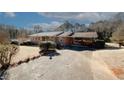 Front view of brick ranch home with driveway at 2963 Thompson Cir, Decatur, GA 30034