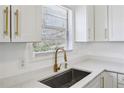 Modern kitchen with white cabinets and gold hardware at 3293 Abbeywood Dr, Decatur, GA 30034
