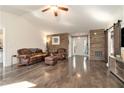 Inviting living room with hardwood floors, rustic wood accent wall, and comfortable seating at 675 Mayes Rd, Powder Springs, GA 30127