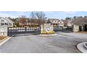 Gated entrance to Heron Pond community with stone pillars at 124 Heron Xing, Woodstock, GA 30188