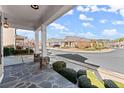 Stone patio and porch with view of the neighborhood at 124 Heron Xing, Woodstock, GA 30188