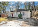Brick ranch house with driveway and mature trees at 1903 Wildwood Dr, Decatur, GA 30032