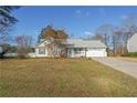 Charming single-story home with a well-maintained lawn and a two-car garage at 115 Muirwood Dr, Temple, GA 30179