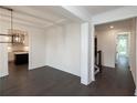 Open dining room with dark hardwood floors and views into the kitchen at 488 Broom Dr, Cumming, GA 30040