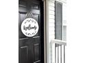 Black front door with a round welcome sign at 213 Moore Valley Way, Canton, GA 30115