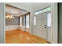 Inviting foyer with hardwood floors, a chandelier, and a view into the adjacent living space at 205 Glenbrook Ln, Canton, GA 30115