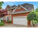 Attractive brick home with a two-car garage, well-maintained landscaping, and a classic architectural design at 205 Glenbrook Ln, Canton, GA 30115