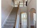 Elegant staircase with a light beige carpet and wooden railings at 1238 Polk Xing, Mcdonough, GA 30252