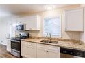 Modern kitchen features granite countertops and stainless steel appliances at 2617 Miriam Ln, Decatur, GA 30032