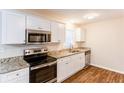 Newly remodeled kitchen with granite countertops and stainless steel appliances at 2617 Miriam Ln, Decatur, GA 30032