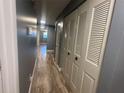 Hallway with light wood flooring and built-in closets at 4626 Midridge Dr, Norcross, GA 30093