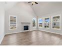 Spacious living room with hardwood floors, a fireplace, and large windows at 507 Pearl St, Cumming, GA 30040