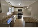 Kitchen with granite countertops, stainless steel appliances, and white cabinets at 1334 To Lani Farm Rd, Stone Mountain, GA 30083